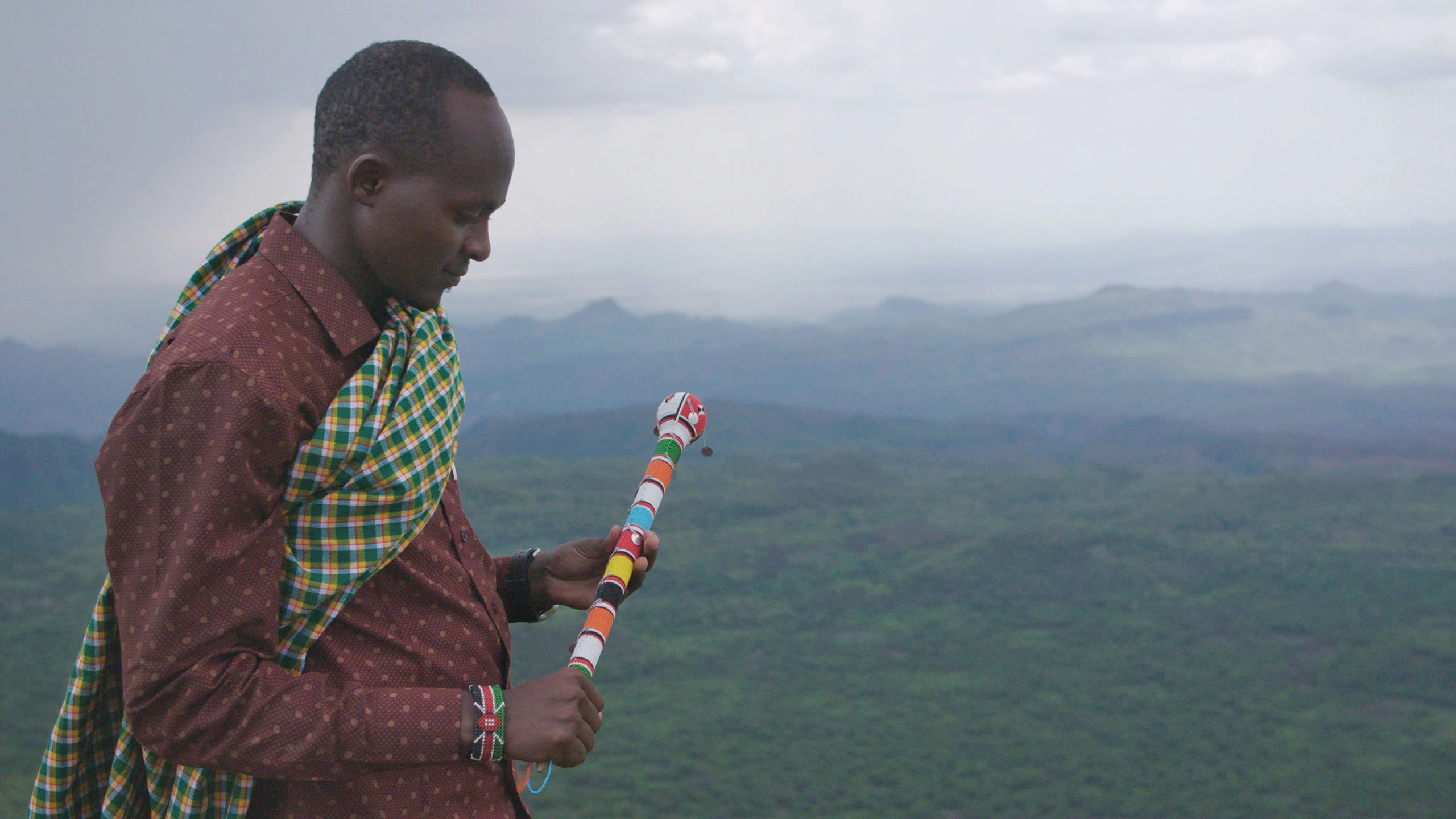 Still from the battle for Laikipia of a man holding a stick