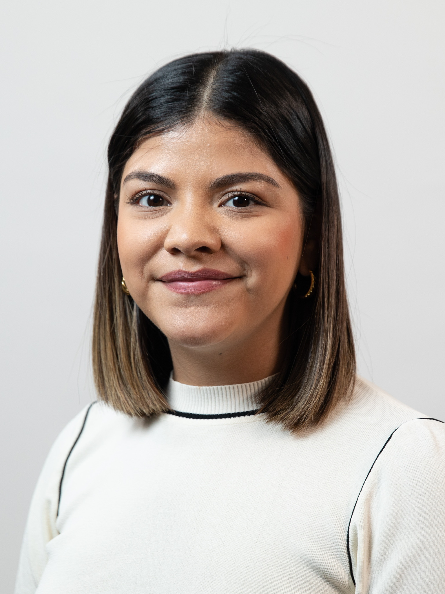 Headshot of Alejandra Martinez wearing a white top