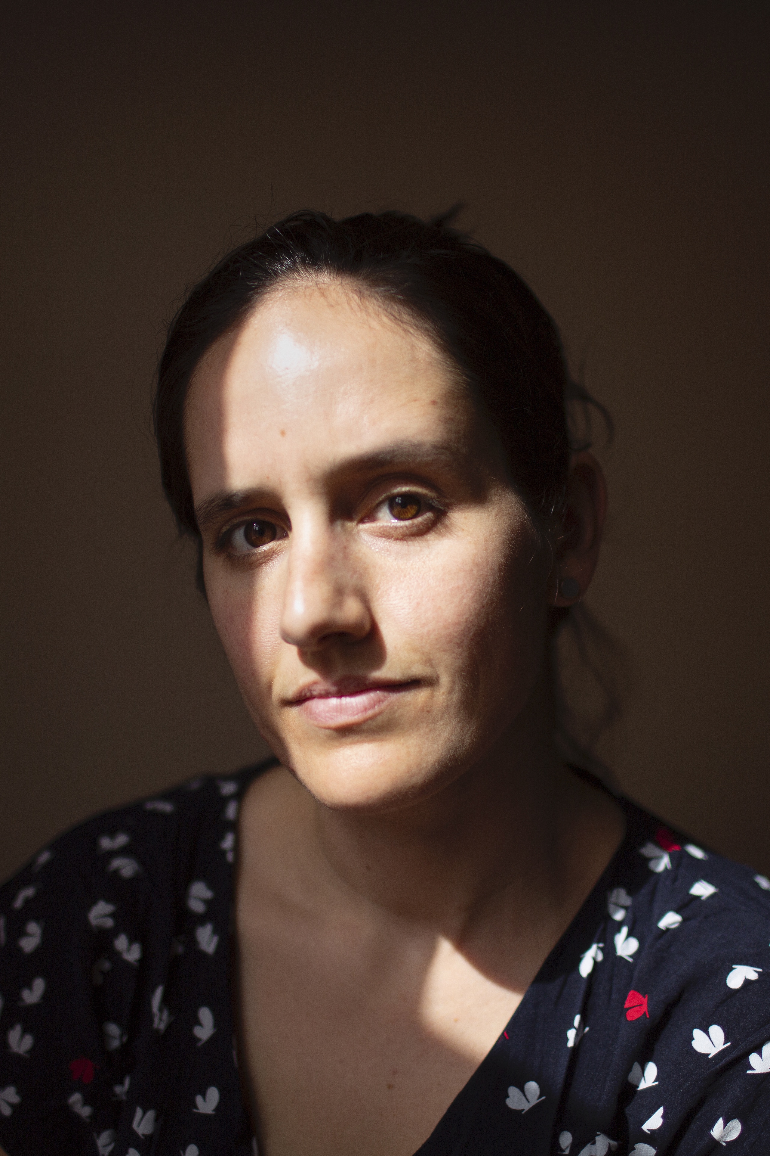 Headshot of Danielle wearing a navy pattered shirt