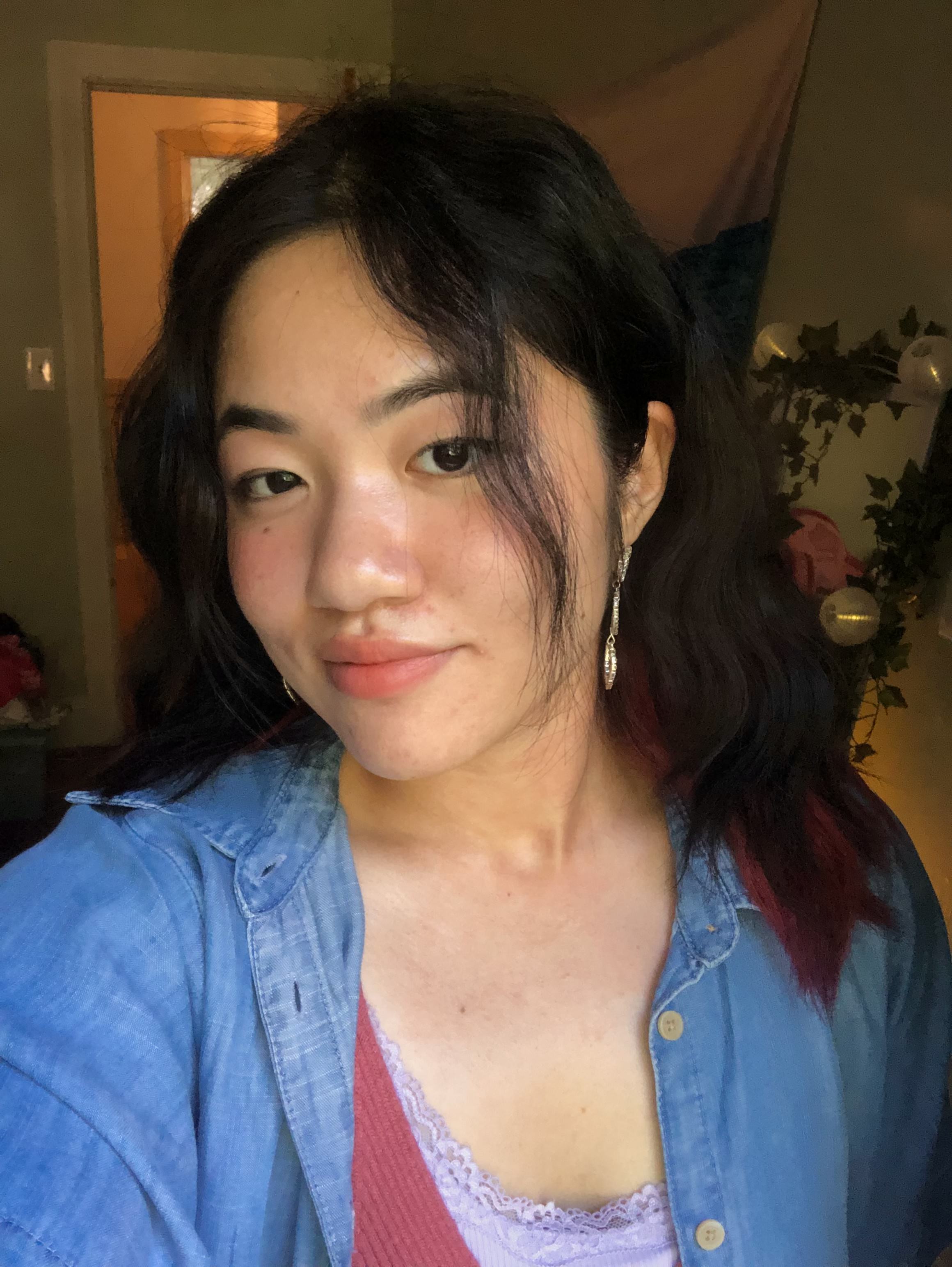 Headshot of Ashley wearing a blue button-down