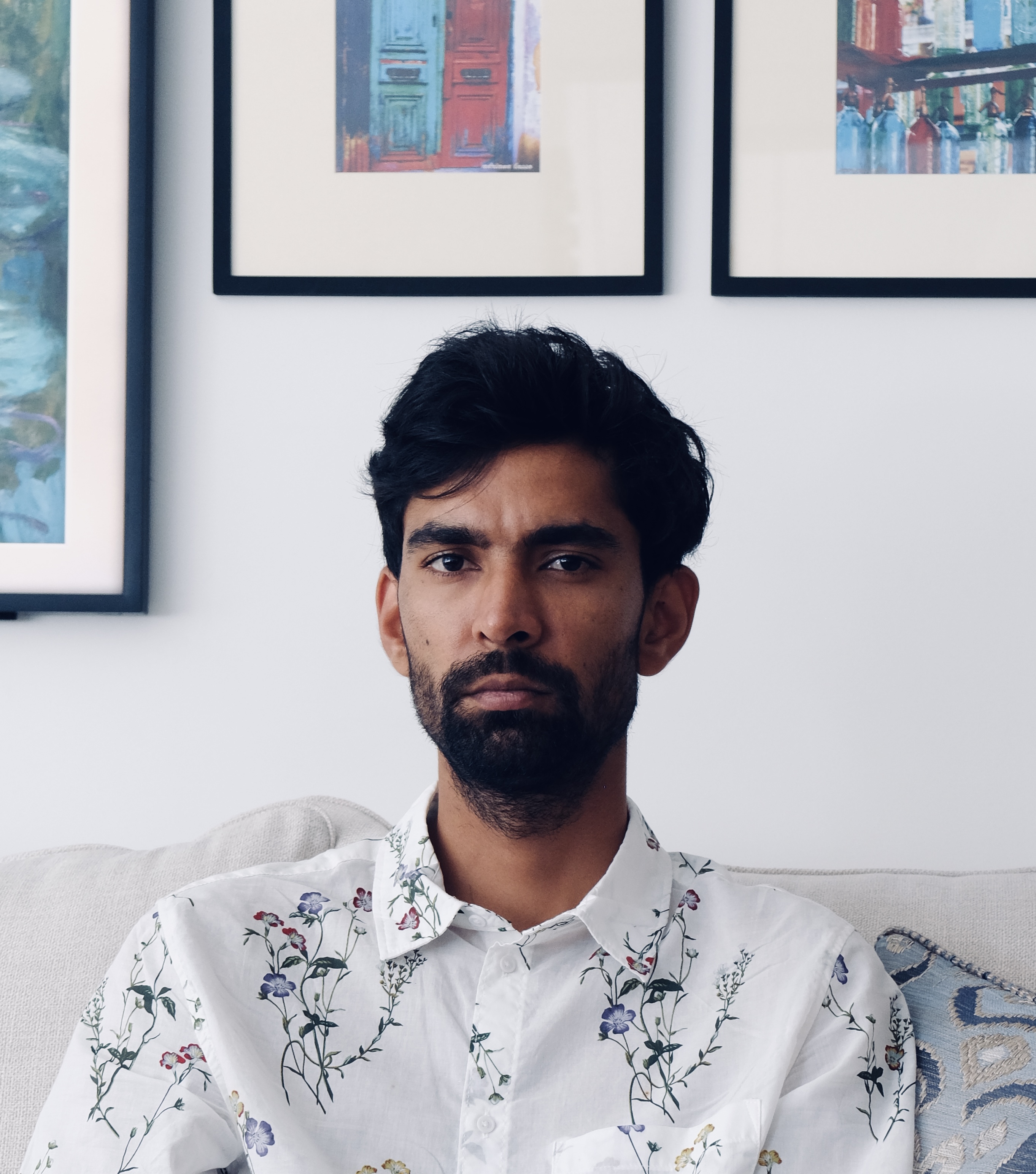 Headshot of Atul wearing a white printed button-down