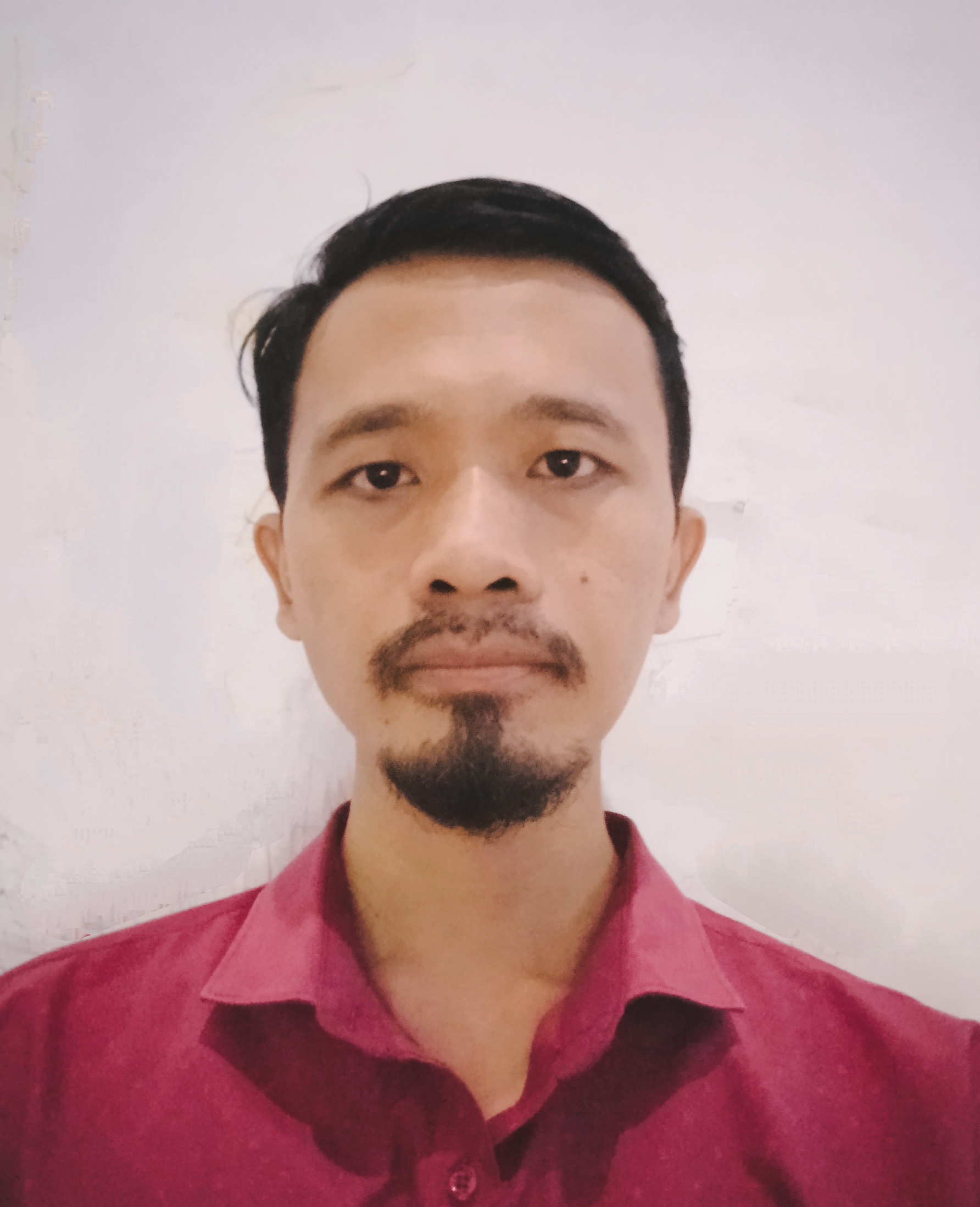 Headshot of Aditya wearing a red collared shirt