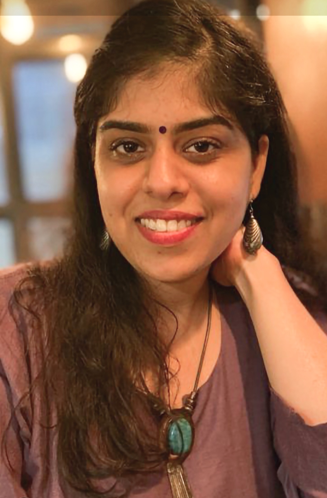 Headshot of Shagun wearing a purple shirt