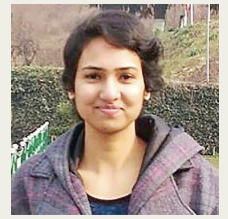Headshot of Rishika wearing a grey jacket