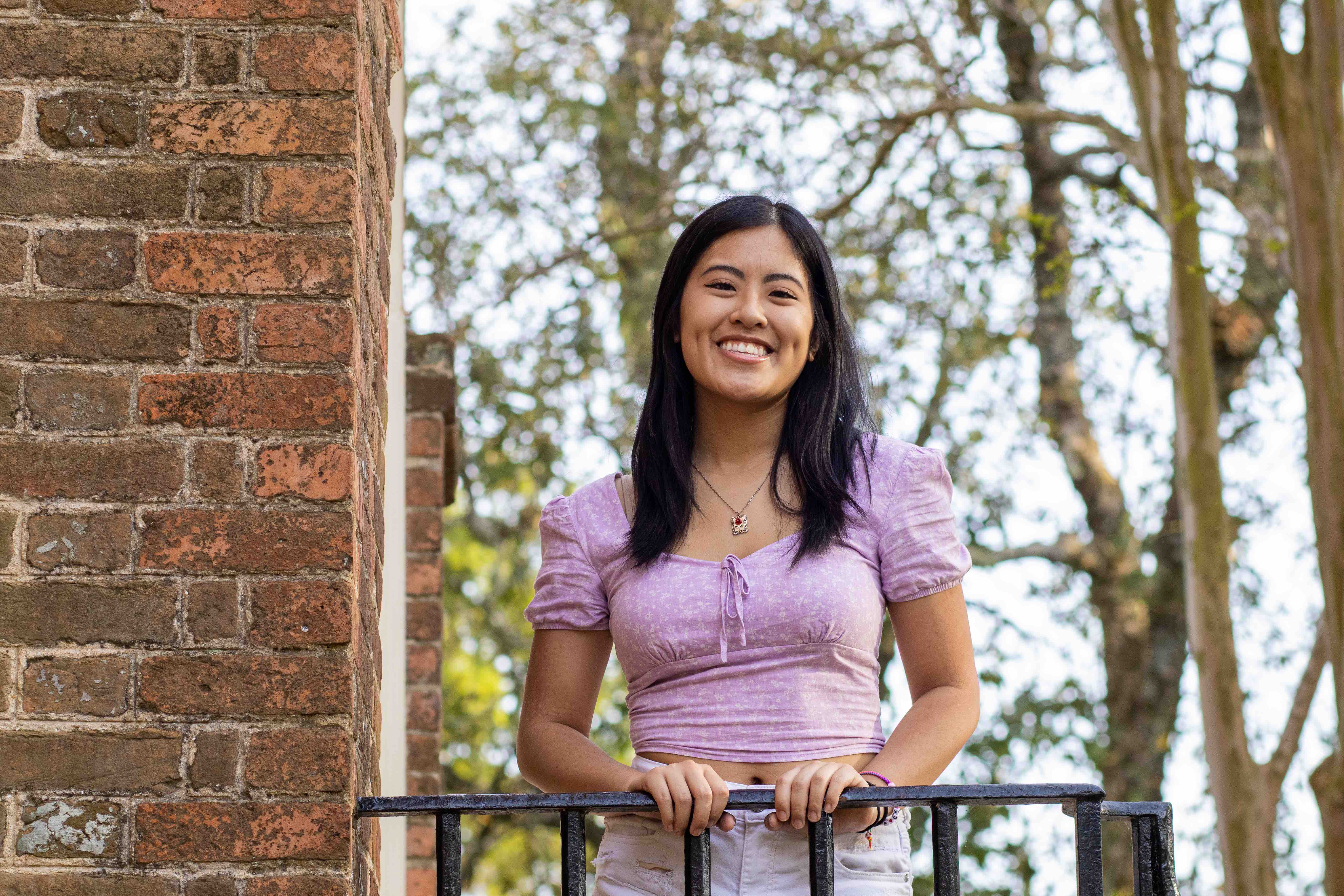 Headshot of Vivian outside wearing purple