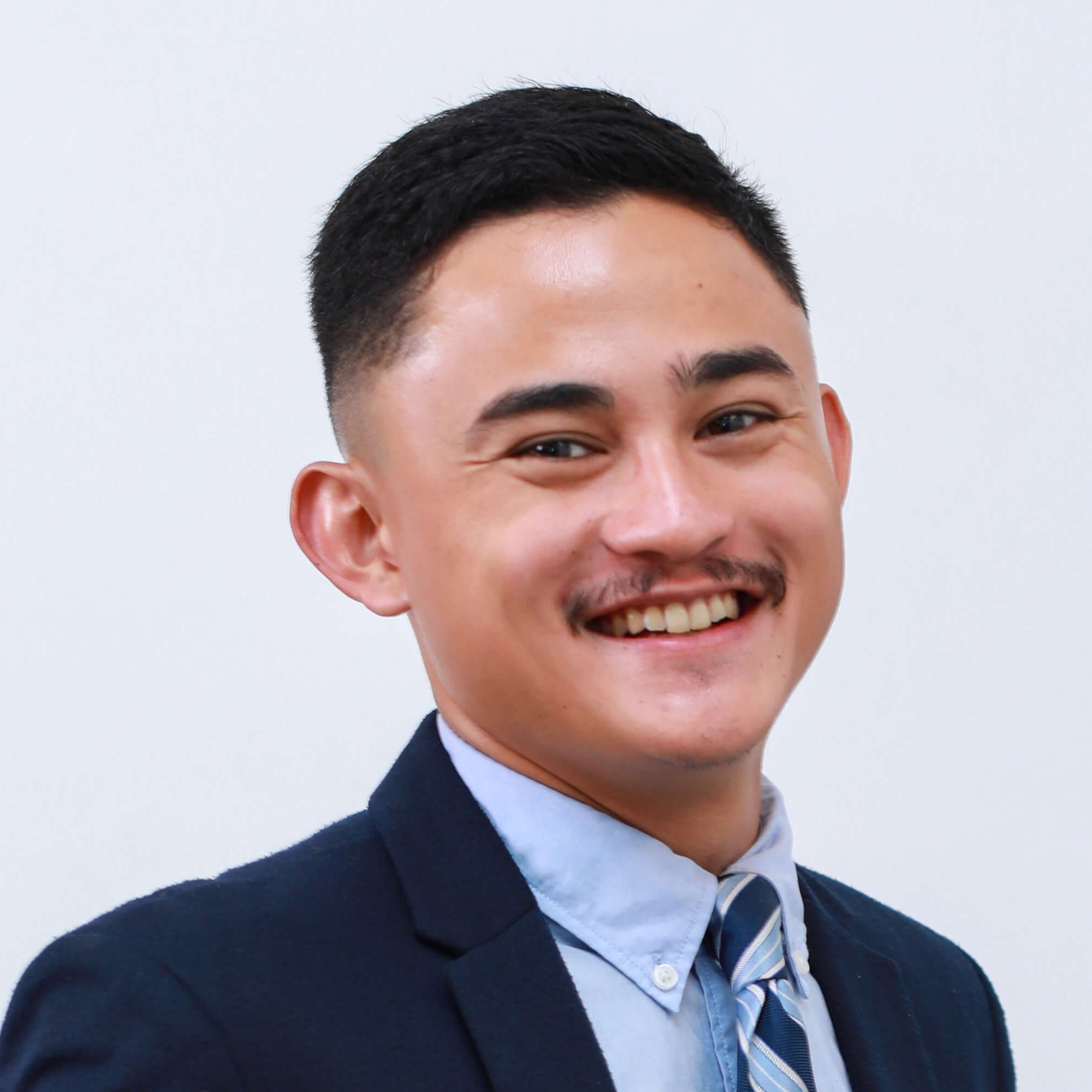 Headshot of man in blue suit