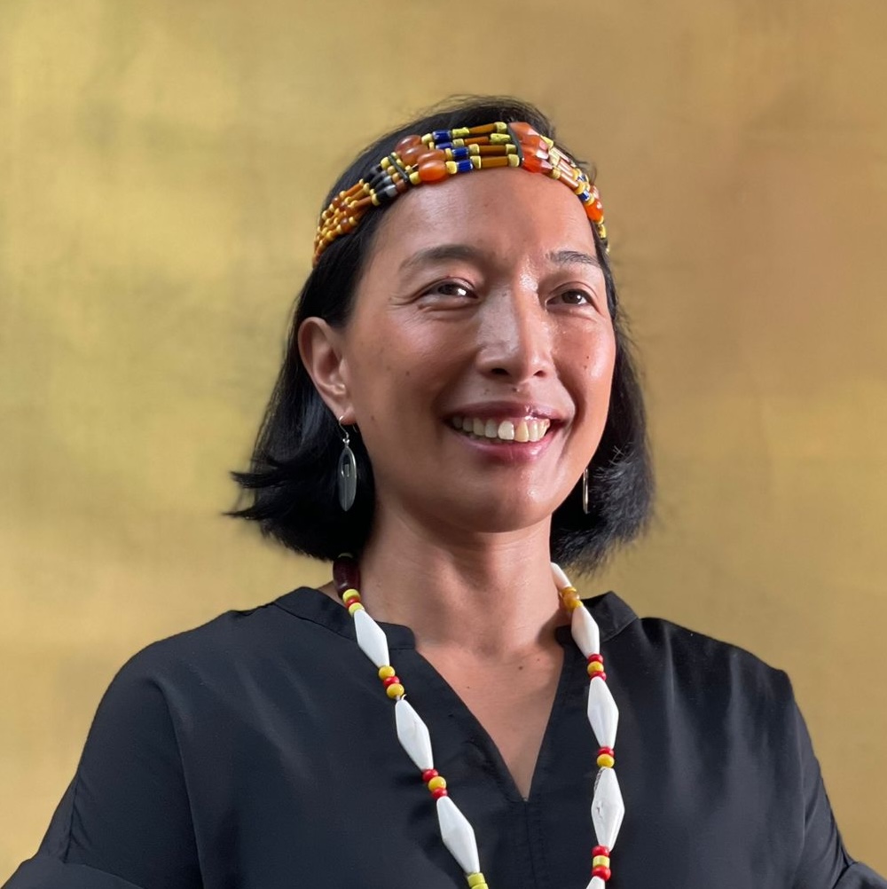 Headshot of woman in black shirt and headband