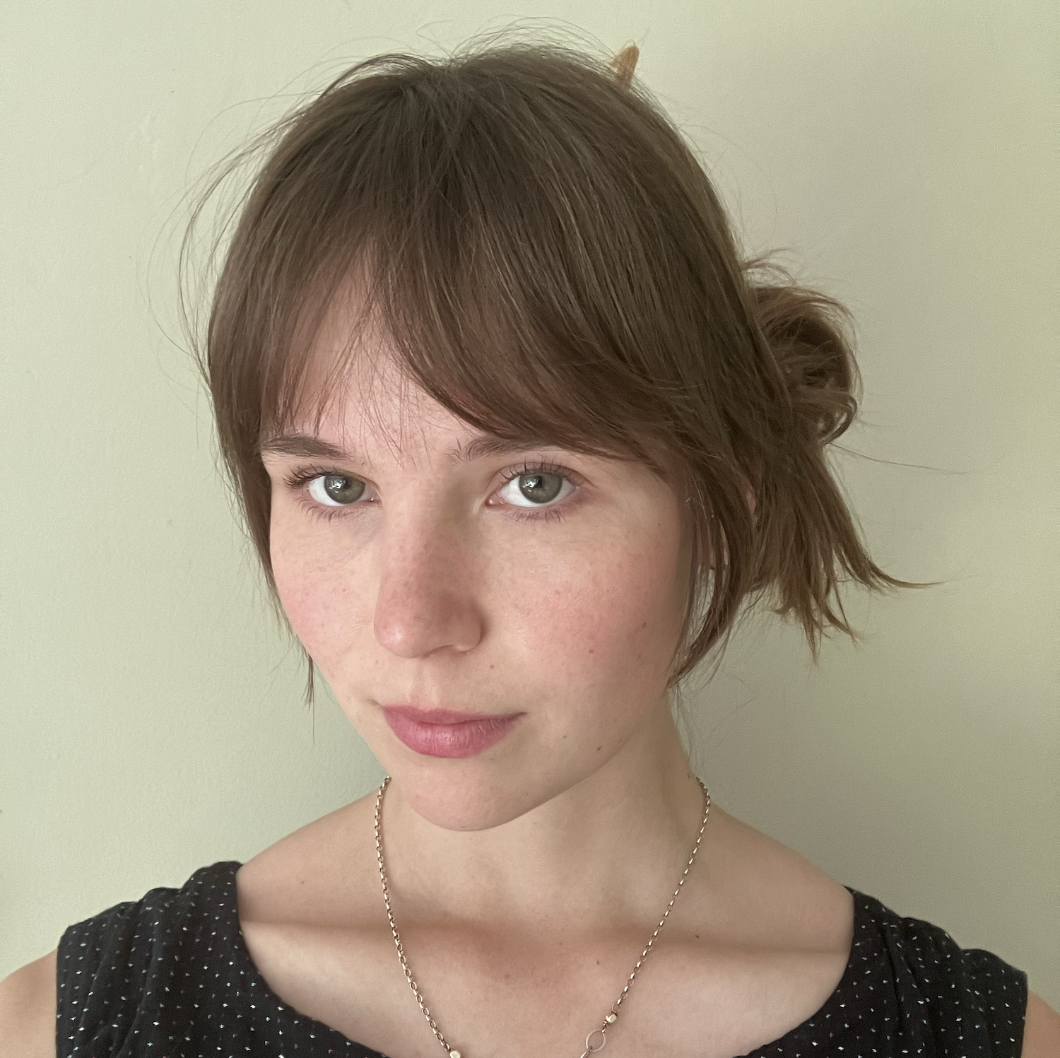 Headshot of woman with brown hair and sweeping bangs