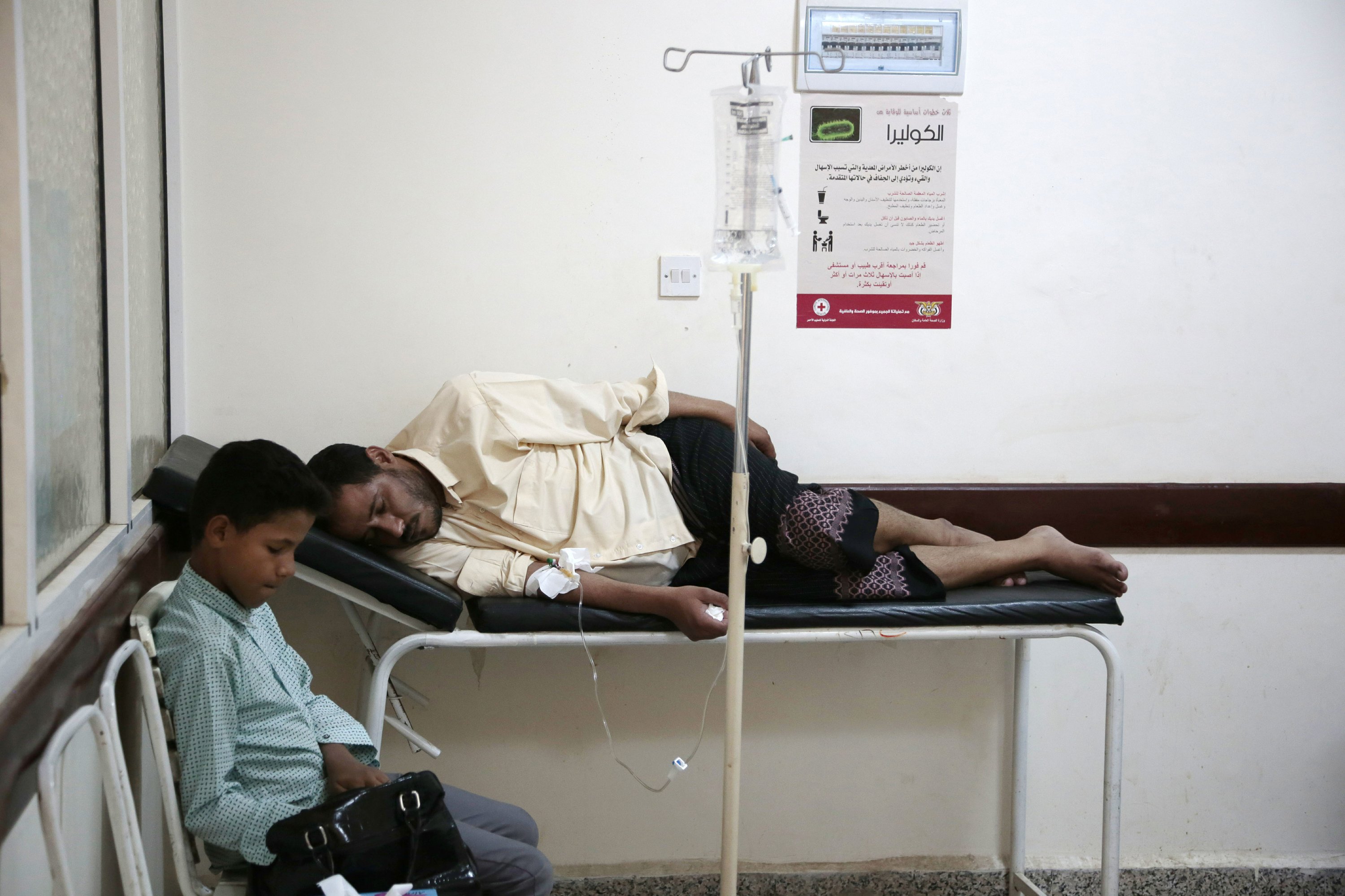 In this July 1, 2017 file photo a, man is treated for suspected cholera infection at a hospital in Sanaa, Yemen. An Associated Press investigation finds that Yemen’s massive cholera epidemic was aggravated by corruption and official intransigence. The investigation has found that both the Iranian-backed Houthis rebels and their main adversary in the war—the U.S.—and Saudi-backed government that controls southern Yemen—impeded efforts by relief groups to stem the epidemic. Image by Hani Mohamed/AP Photo. Yemen, 2017. In this July 1, 2017 file photo, a man is treated for suspected cholera infection at a hospital in Sanaa, Yemen. An Associated Press investigation finds that Yemen’s massive cholera epidemic was aggravated by corruption and official intransigence. The investigation has found that both the Iranian-backed Houthis rebels and their main adversary in the war—the U.S.—and Saudi-backed government that controls southern Yemen—impeded efforts by relief groups to stem the epidemic. Image by Hani Mohamed/AP Photo…