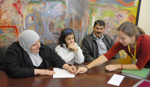 From left, Jenan, Zahra and Issam, who came to Baltimore in August, work with Sara Bedford, their case manager at the International Rescue Committee, in a follow-up meeting over employment. (Baltimore Sun photo by Chiaki Kawajiri / December 23, 2008) 1