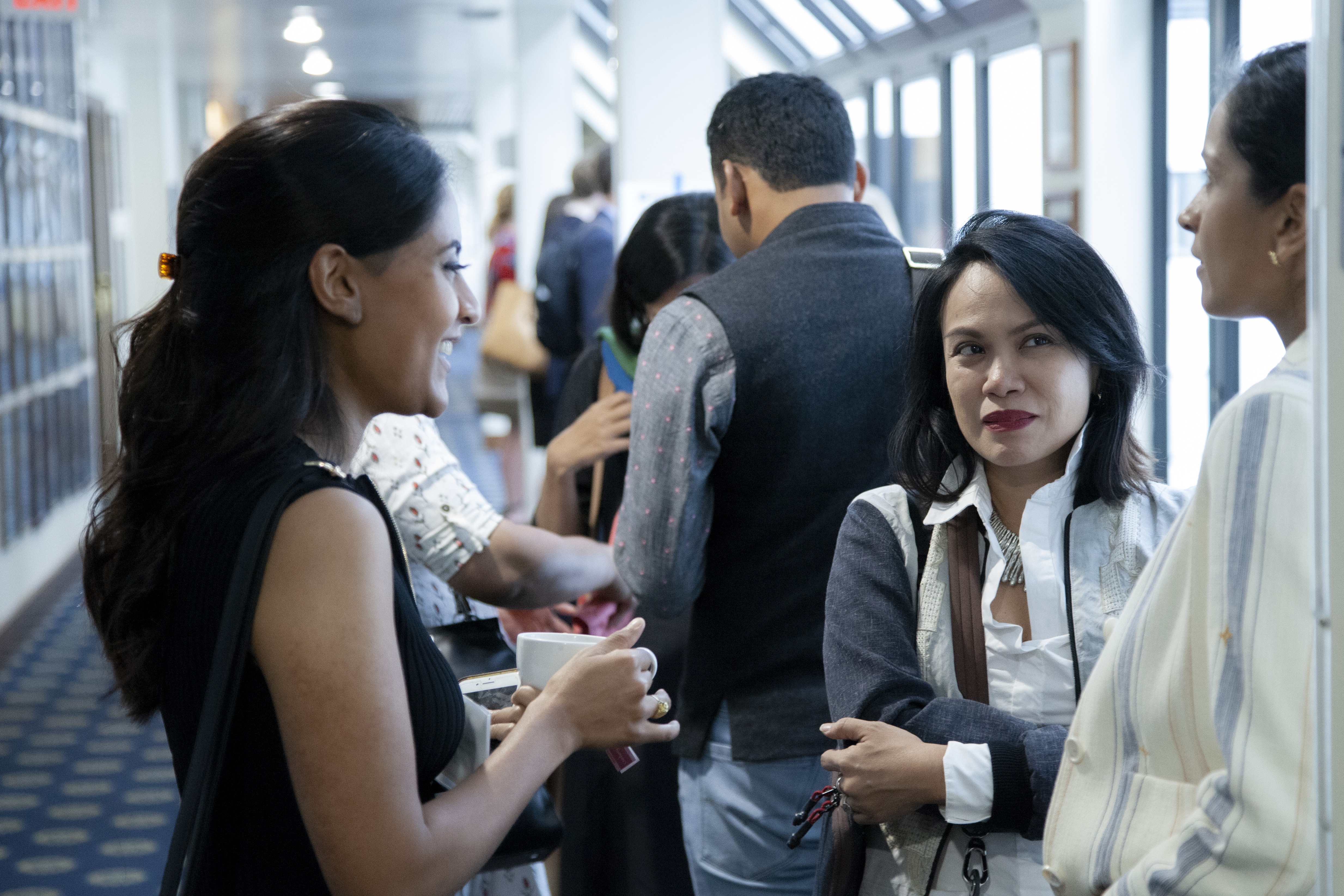 In between panels, journalist grantees Ana Santos (center) and Krithika Varagur (left) chat over coffee with journalist grantee Sushma Subramanian. Image by Jin Ding. United States, 2019. In between panels, journalist grantees Ana Santos (center) and Krithika Varagur (left) chat over coffee with journalist grantee Sushma Subramanian. Image by Jin Ding. United States, 2019.