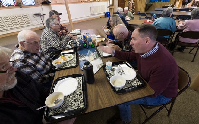Dairy farmer Randy Roecker, right, talks with retired dairy farmer Hank Elfers, second from left, at St. Peter's Lutheran Church in Loganville. Roecker helped organize "Farm Neighbors Care" events to help farmers who need support. Image by Mark Hoffman. United States, 2020. Dairy farmer Randy Roecker, right, talks with retired dairy farmer Hank Elfers, second from left, at St. Peter's Lutheran Church in Loganville. Roecker helped organize "Farm Neighbors Care" events to help farmers who need support. Image by Mark Hoffman. United States, 2020.