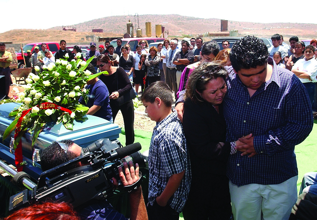 Central America now has the highest homicide rate in the world. Gabriela Ramírez is comforted at the funeral of her husband, Francisco Ortiz Franco, an editor of Zeta, a muckraking weekly in Tijuana, Mexico. Image by Knight Foundation, Flickr. Mexico, 2010. Media file: 5568594845_1278a4d79f_b.jpg