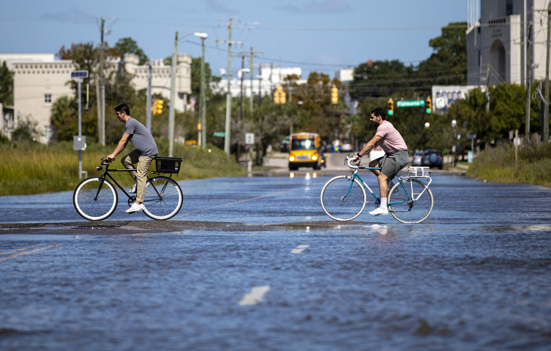 Bicyclists pedal through floodwater at the intersection of Hagood Avenue and Line Street on Monday, Sept. 21, 2020, in Charleston. Image by Andrew J. Whitaker / Post and Courier. United States, 2020.