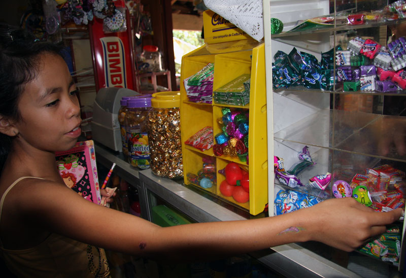Karla Patricia Posadas, 10, visits a local store after an exam to buy some candy with her friends. Image by Tracy Boyer. Honduras, 2009.