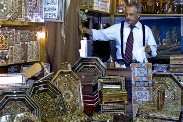 Tourism has collapsed in Syria. In the famous Damascus souk, or marketplace, businessmen like this one haven’t seen foreign customers in months. Image by Reese Erlich. Syria, 2011. Media file: 7-no_custome_ropped.jpg