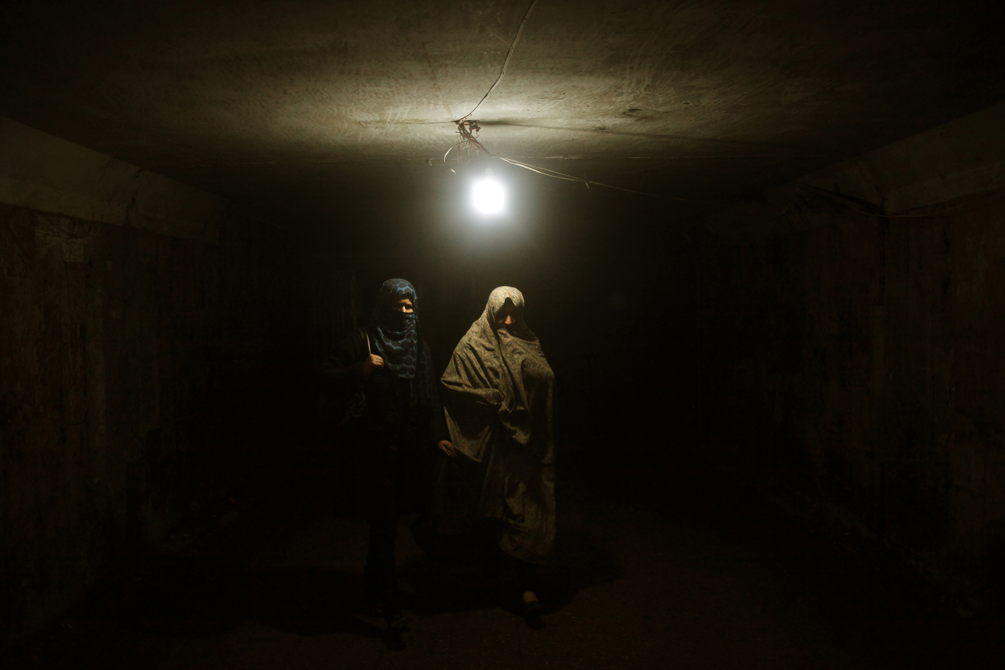 Women walking in an underground pedestrian corridor in Kabul. Image by Seamus Murphy. Afghanistan, 2012. Media file: AfghanPoetry_Pulitzer_SeamusMurphy014.jpg
