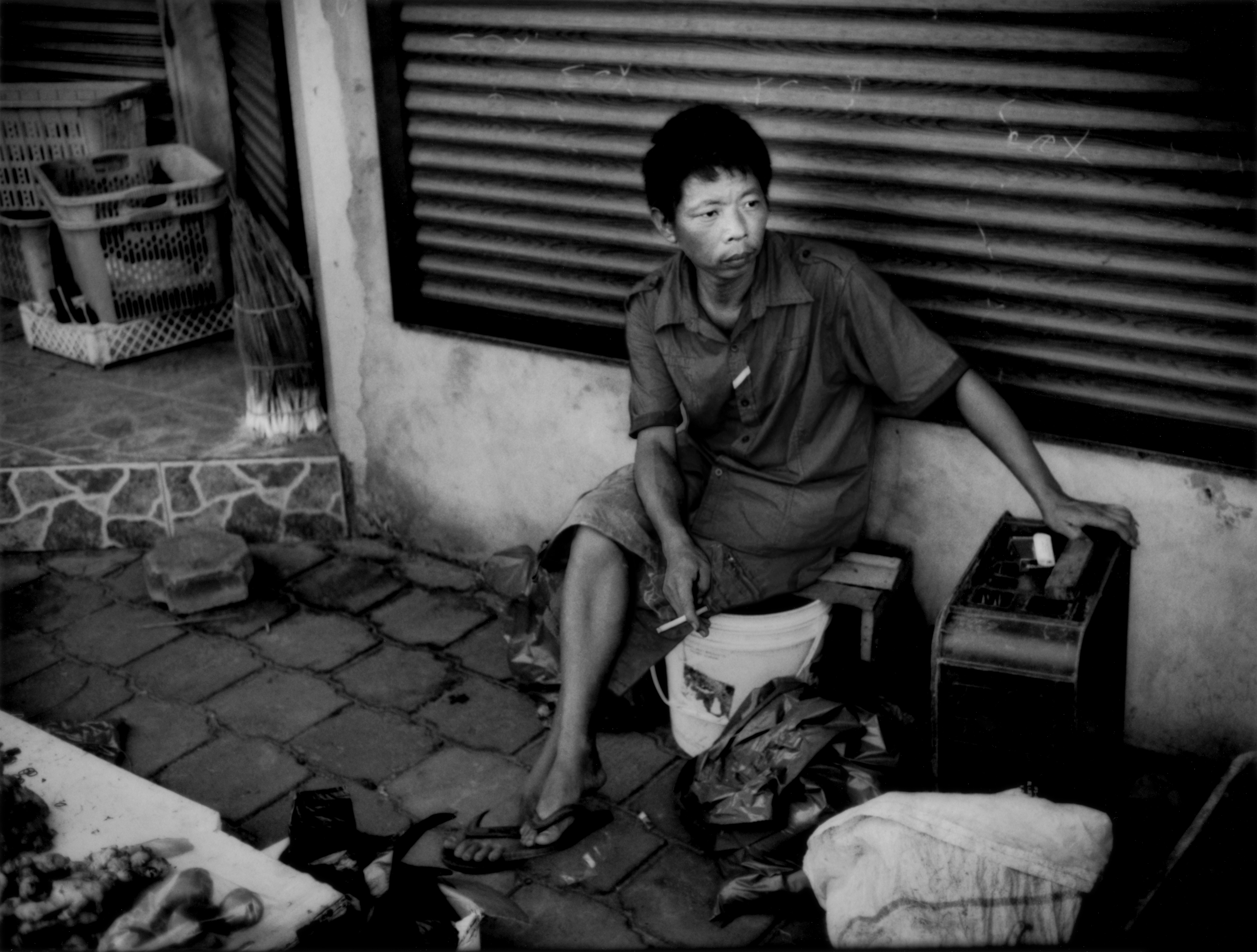 Mr. Ling, a vendor and a migrant from the People's Republic of China, sells vegetables native to China at a market in Paramaribo's tiny Chinatown. Suriname, with a population of less than 500,000, has a small ethnic-Chinese community that dates from colonial times. But it is the recent influx of larger numbers of migrant workers from China that raises tensions. Image by James Whitlow Delano. Suriname, 2012. Media file: Delano_Suriname_China_006.jpg