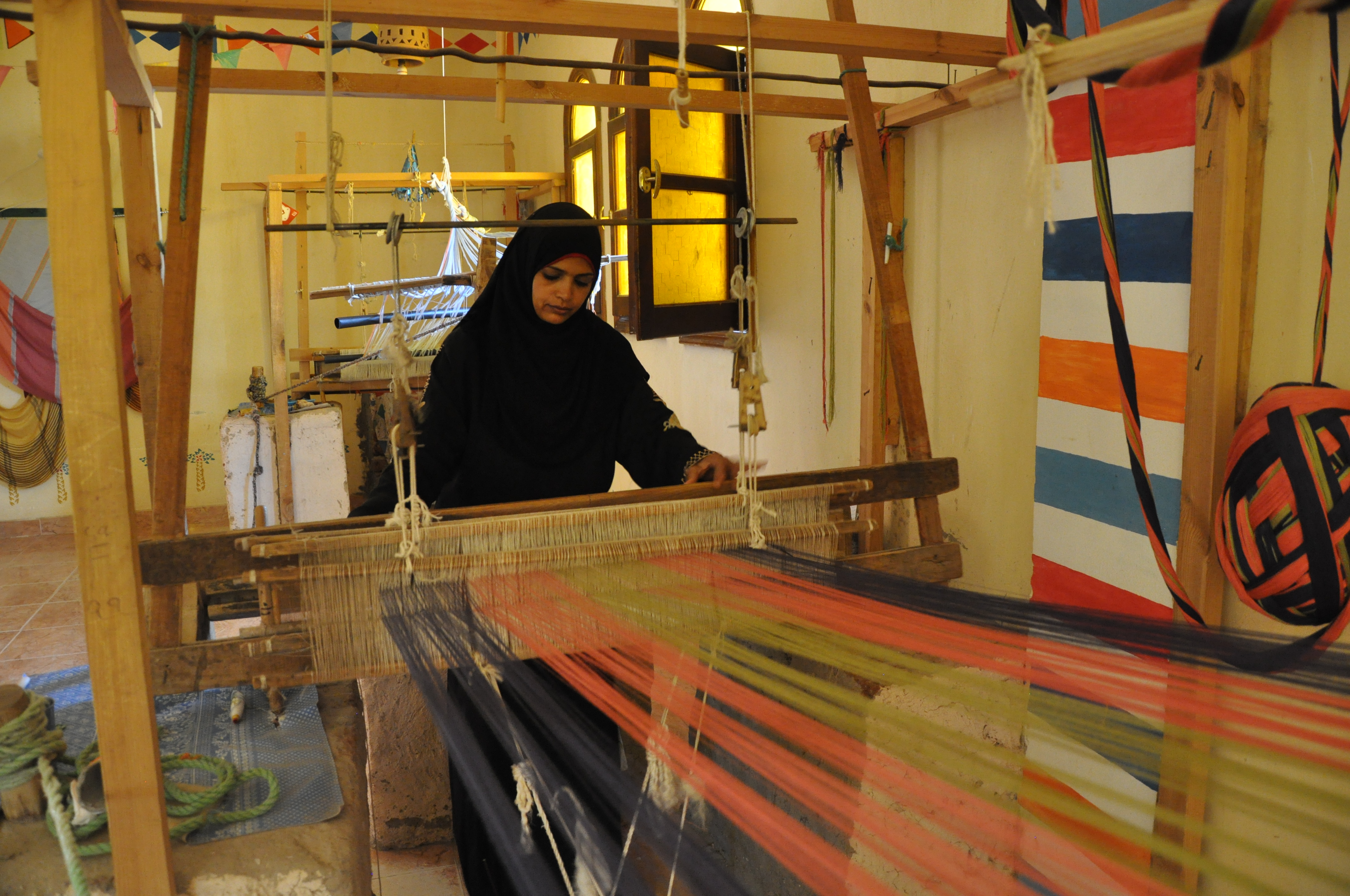 Amira Sayeed, 20, weaves a tapestry at the Nubian Cultural Center in Luxor, Egypt. Ghazali hopes to showcase and sell handicraft like Sayeed's on his website "Yadaweya," or Handmade in Arabic. Image by Lauren E. Bohn. Egypt, 2012. Media file: EgyptEntrepreuners.jpg