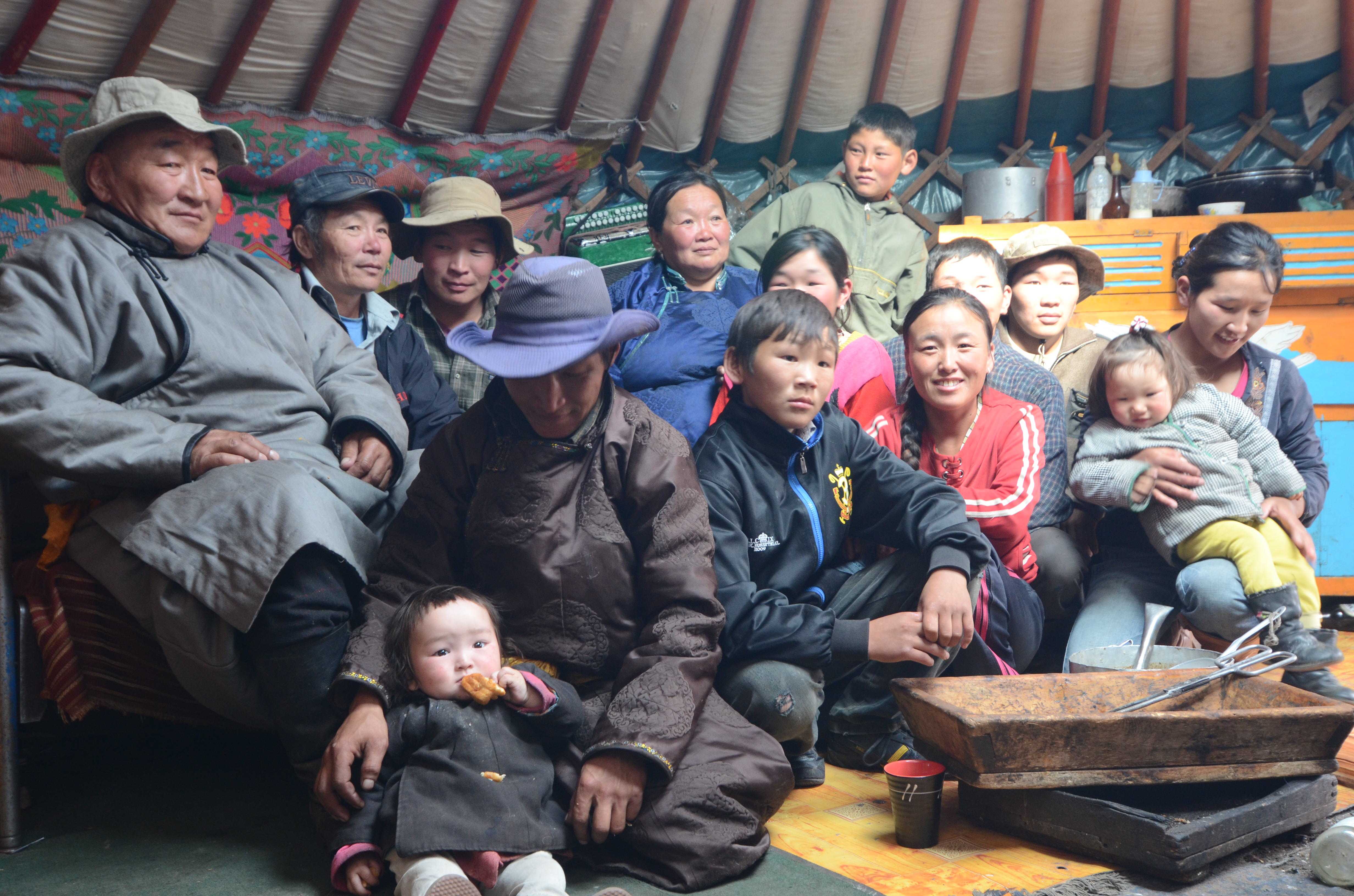 Nomadic herder Hurelchuluun (far left), his wife (center rear, in blue) and some of their extended family. Image by Daniel Grossman. Mongolia, 2011. image
