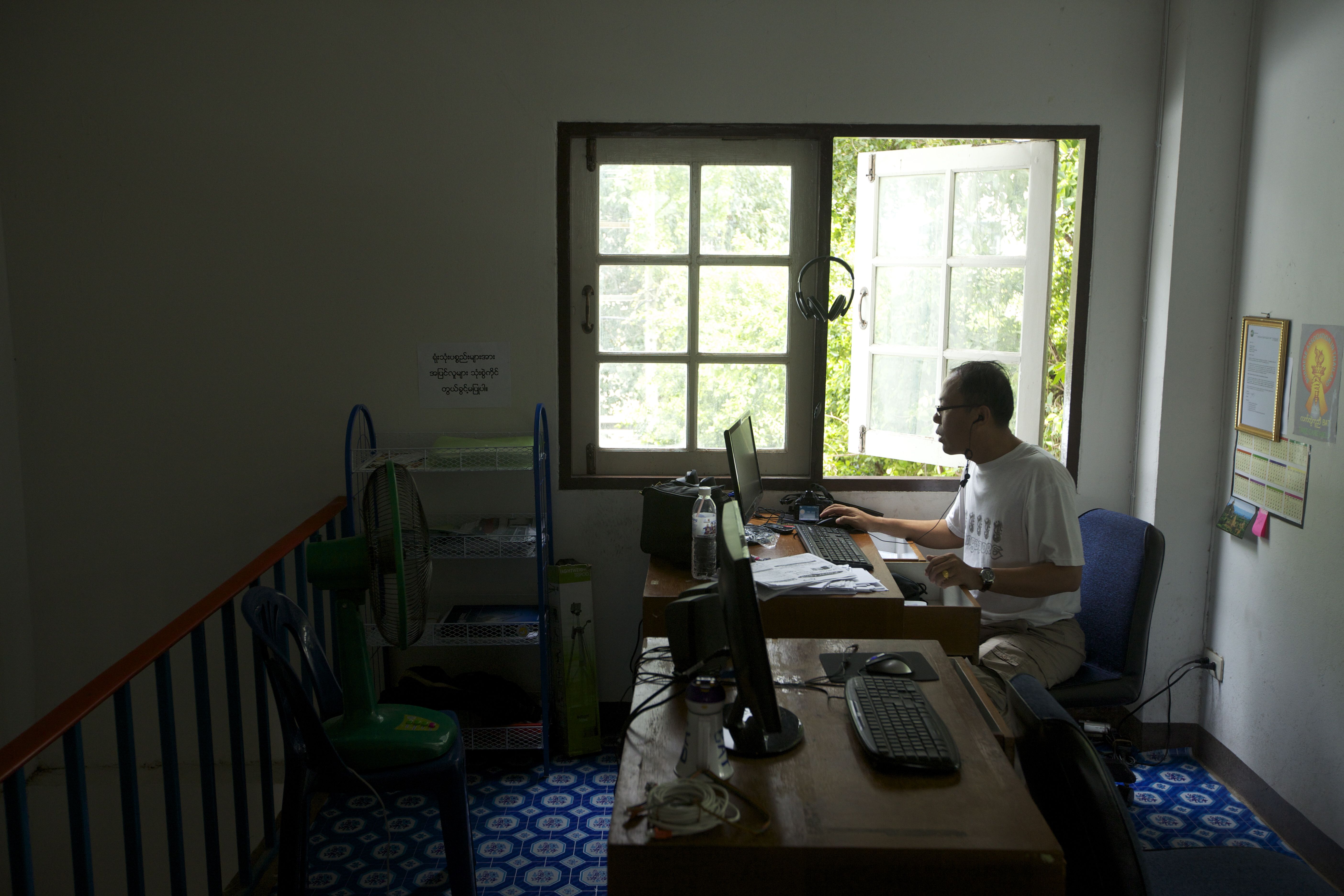 The reporter Kyaw Thaung at work in his office on the outskirts of Bangkok. Image by Jason Motlagh. Thailand, 2012. Media file: IMG_7346journo.jpg