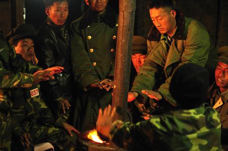 KIA soldiers warm themselves around a coal fire on cold night at Laisin. Image by Ryan Libre, Myanmar, 2009. Media file: Kachin-Myanmar.jpg