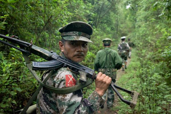 Kachin Independence Army fighters on patrol near the frontline, southern Kachin state. A Burmese Army outpost sits about a mile away from their forward outpost. Image by Jason Motlagh. Burma, June 2012.