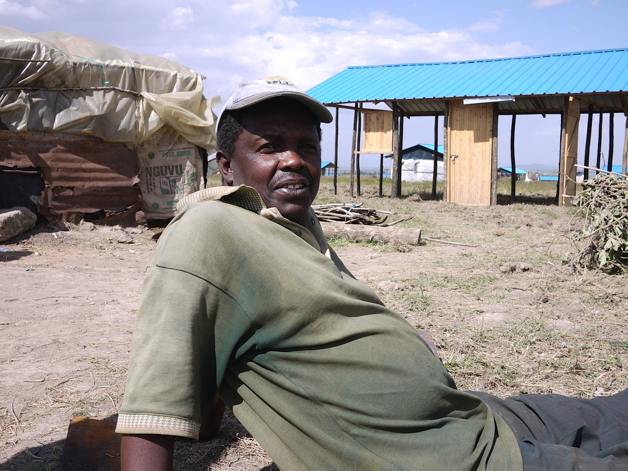 Edward Kafuko was forced to flee his town during the 2007-2008 post- election violence that rocked the country. Since then, Kafuko has been in a series of displaced persons camps. He says it is too dangerous to return to his community. He has now been resettled to a new community in Laikipia, where after three months the government had only partially finished construction. He currently lives in a makeshift home of mud and scraps. “I never thought I would leave home, but now I canʼt go back,” he said. Image by Sam Loewenberg. Kenya, 2012. Media file: Kenya election photo.jpg
