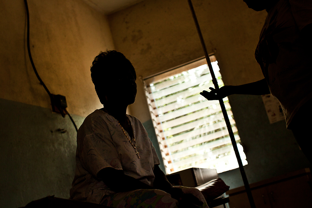 Mae Azango (right) discusses the challenges of working as a midwife with Annie Gobah, a trained traditional midwife from Todee, Liberia. Image by Jake Naughton. Liberia, 2012.