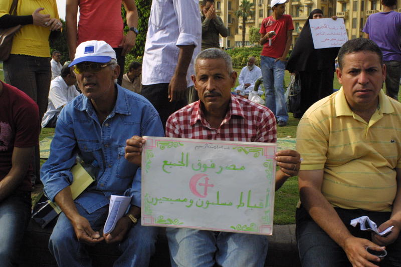 At a Tahrir Square rally, a man holds a sign calling for solidarity of Muslims and Christians. Image by Reese Erlich. Egypt, 2011. image