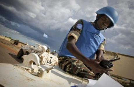 A handout picture released by the United Nations Mission in Sudan (UNMIS) shows a Namibian soldier serving with the international peacekeeping operation on the ground during a patrol in the volatile region of Abyei on May 30, 2011. Image by Stuart Price AFP/Getty Images. Sudan, 2011.