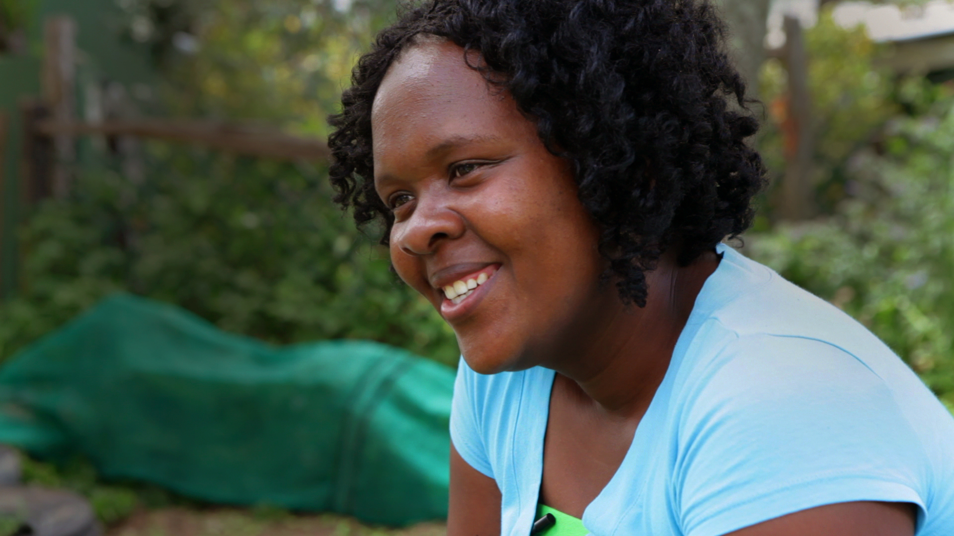 Ntuthu pauses and smiles during a video interview in which she tells the story of living with HIV and becoming a mother. Image by Samantha Thornton. South Africa, 2012. Media file: ST_NtuthuStill-1.jpg