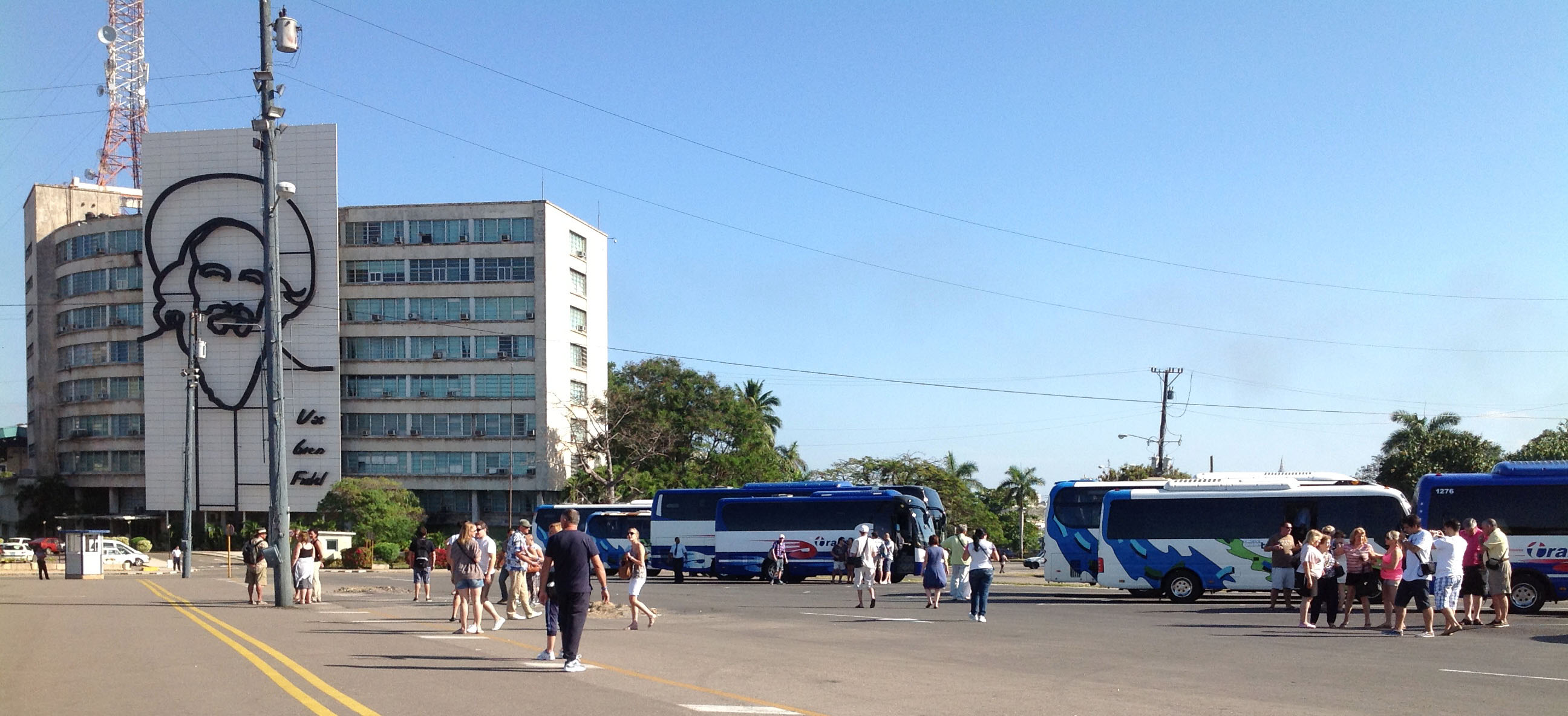 Tourist buses line up in La Plaza de Revolucion in Havana, full of visitors from across the globe. Groups from the United States are required to travel with a government-approved tour guide. Image by Rachel Southmayd. Cuba, 2013. Media file: Southmayd5.jpg