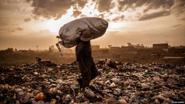 Less than 5km (two miles) from central Nairobi lie the smouldering mountains of rubbish thrown away by the residents and businesses of the Kenyan capital. Dandora is one of Africa's largest dumping and scavenging grounds. Every day thousands of slum dwellers try to eke out a living. This man took nearly three hours to fill his last bag of the day—and he hopes to sell the contents, which are mostly scraps of rubber, for $0.50 (£0.30). Image by Micah Albert. Kenya, 2012.