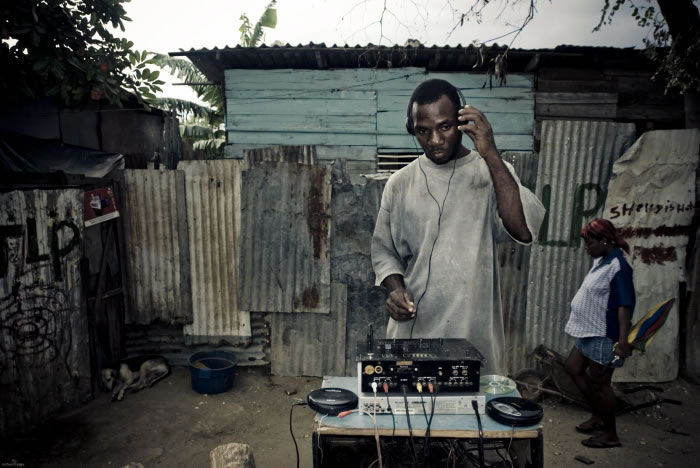 Lascelles, who is HIV positive, stands in his community of Spanish Town, a rough ghetto on the outskirts of Kingston. Image by Joshua Cogan. Jamaica, 2009.