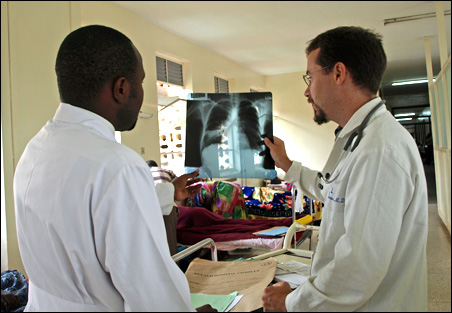 Dr. Michael Ssonko, left, and Dr. David Boulware study an x-ray of an HIV patient. Image by Sharon Schmickle. Uganda, 2008. Media file: cfkz52.jpg