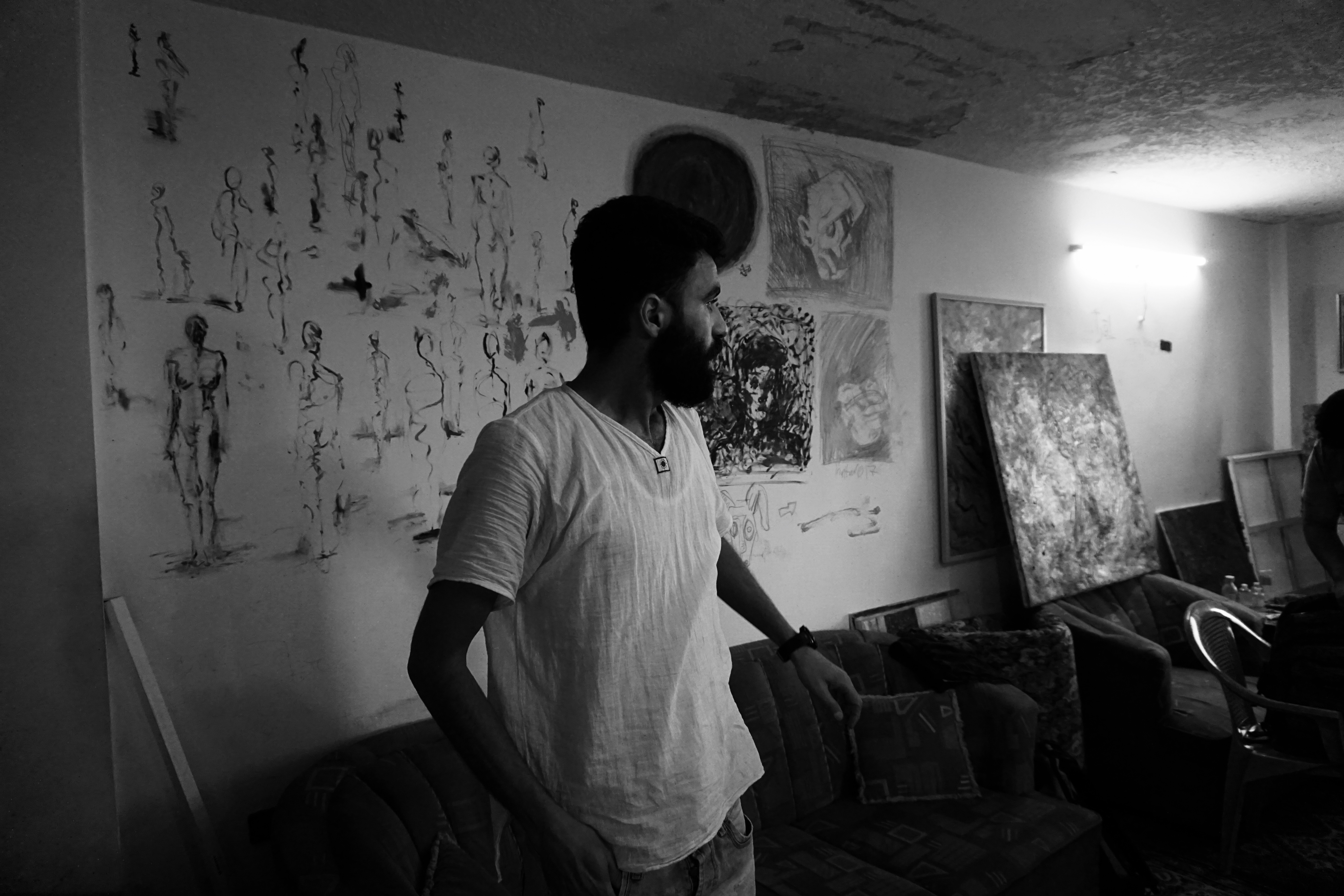 Emsallam Hdaib looks at his artwork in his Amman studio. Image by Aman Madan. Jordan, 2017. Emsallam Hdaib looks at his artwork in his Amman studio. Image by Aman Madan. Jordan, 2017.