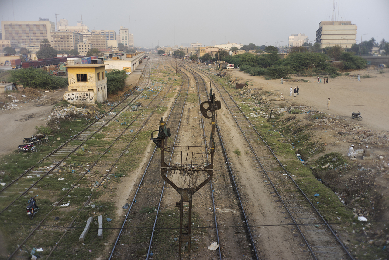 Tracks under Karachi Port Trust Interchange, Karachi, Pakistan. Image from KCR, by Ivan Sigal. Pakistan, 2014-2017. Tracks Under Karachi Port Trust Interchange, Karachi, Pakistan. Image from KCR, by Ivan Sigal. Pakistan, 2014-2017.