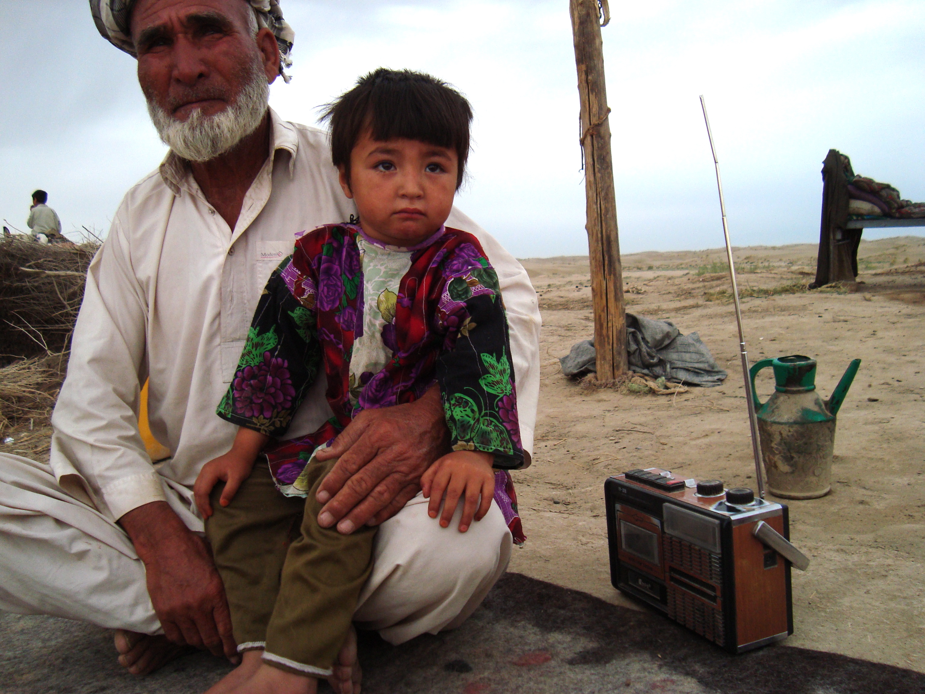 . . .They will return it to Baba Nazar, a village elder, who will listen to the news and explains it to his 4-year-old granddaughter, Leila. Image by Anna Badkhen. Afghanistan, 2011. Media file: dsc03509_9777_11007.jpg