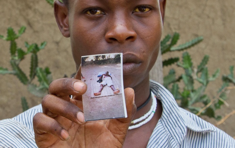 A man holds a picture of himself taken when he was incapacitated by cholera. For many, the completion of a cholera vaccine campaign in Haiti means that they will not suffer the same fate. Image by Meghan Dhaliwal. Haiti, 2012. Media file: forvaccine.jpg