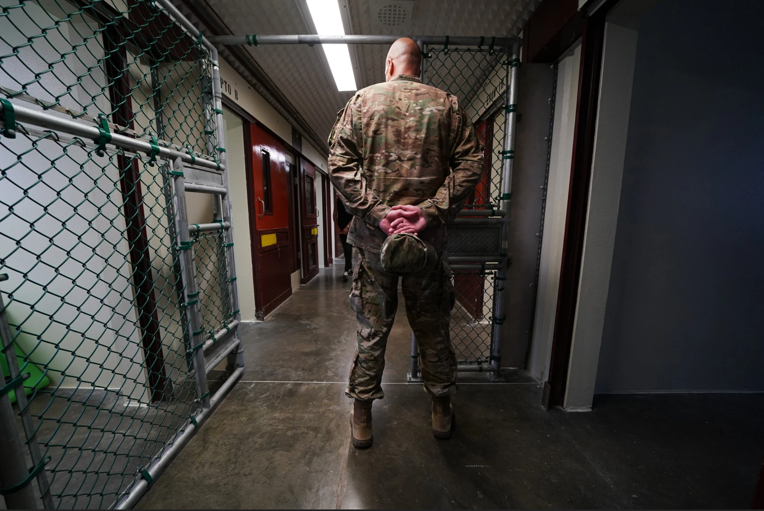 A member of the military at Guantanamo Bay’s detention center. For most of two decades, the United States has been holding five men accused of helping plot the September 11, 2001 attacks. Image by Doug Mills for The New York Times. United States, undated. A member of the military at Guantanamo Bay’s detention center. For most of two decades, the United States has been holding five men accused of helping plot the September 11, 2001 attacks. Image by Doug Mills for The New York Times. United States, undated.