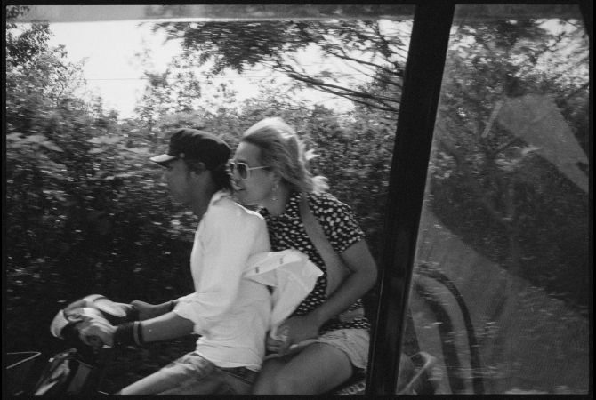 A young couple rides a motorcycle from Puin Oo Lin to Mandalay on the Burma Road. Image by Gary Knight. Burma, 2012.