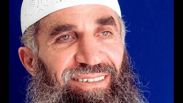 Guantánamo prisoner Abd al Hadi al Iraqi, who says his true name is Nashwan al Tamir, poses for the International Red Cross in a 2014 photo taken for his family. Image provided by Hadi's attorneys. 2014. Guantánamo prisoner Abd al Hadi al Iraqi, who says his true name is Nashwan al Tamir, poses for the International Red Cross in a 2014 photo taken for his family. Image provided by Hadi's attorneys. 2014.