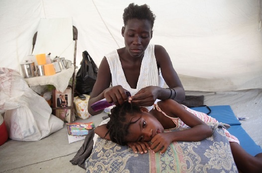 Nadine has been caring for her two children since her husband left three years ago, when she told him that she had HIV. Image by Andre Lambertson, Haiti, 2010.