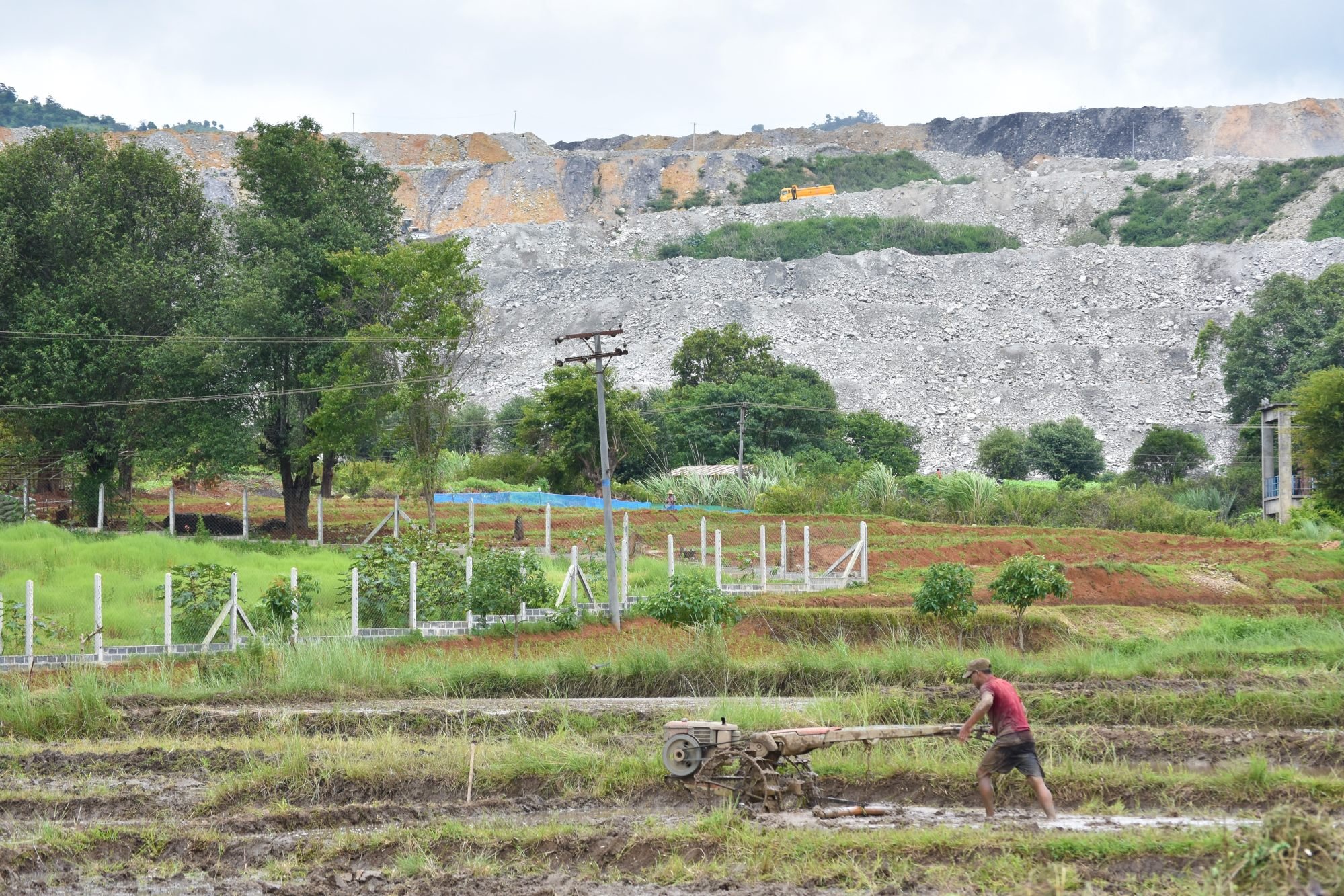 a farmer operating a machine in a field