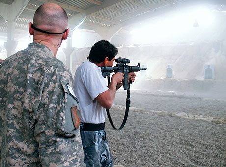 Major Dillon Haynes showing an Iraqi trainee how to shoot an M4. Minutes later the range was mobbed by administrative staff; photo by Dimiter Kenarov. 1