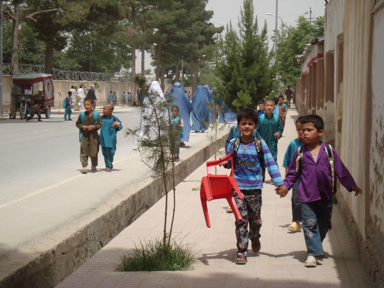 Schoolboys in Maimana, the capital of Faryab province. In most of the province, the Taliban control the streets by night and the government of Hamid Karzai controls the province by day. Image by Anna Badhken. Afghanistan, 2011. Media file: maimana_10661.jpg