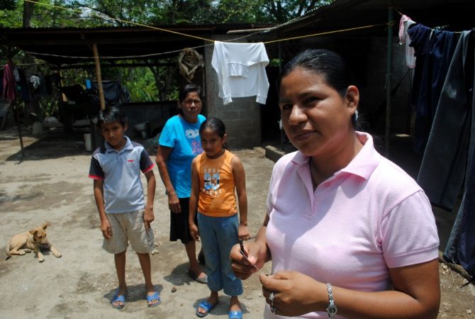 Martha Acuña at home in Masaya, Nicaragua with her mother and two children. Her husband's death in a motorcycle accident left her as the only wage-earner in the eight-member household. Image by Tim Rogers. Nicaragua, 2012. Media file: martha_2.jpg
