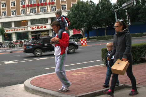 Victoria and Konstantin Petrashev strolled along Heihe streets with their two sons, aged seven and four. The Petrashev family moved to China from Abakhan in search of a better life. Image by Anna Nemtsova. China, 2012.