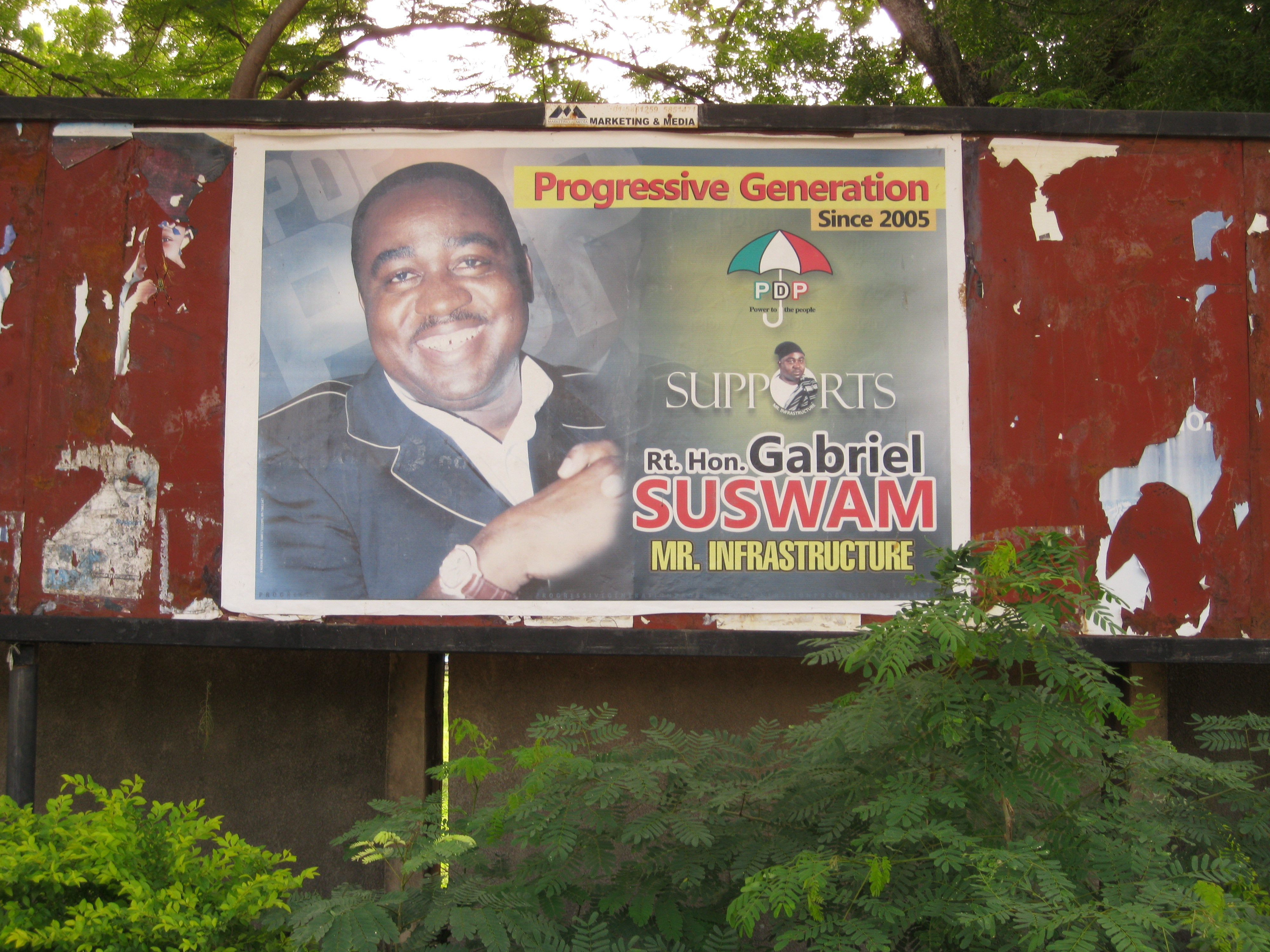 A political ad for the current governor, Gabriel Suswam. Locals call the new water works "his baby." Image by Peter Sawyer. Nigeria, 2011.